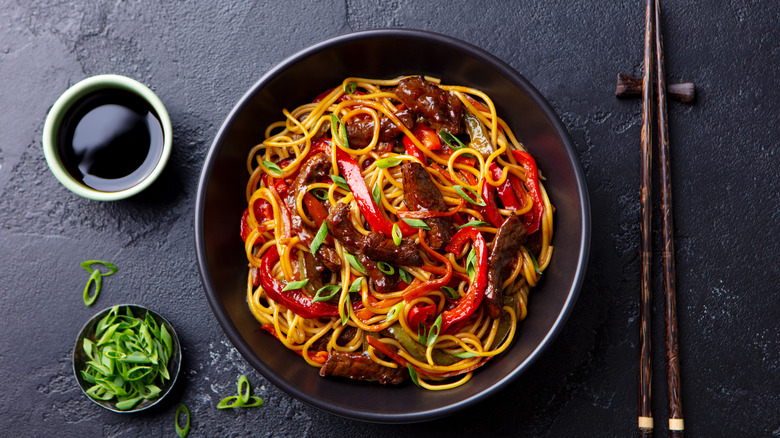 beef noodles in black bowl