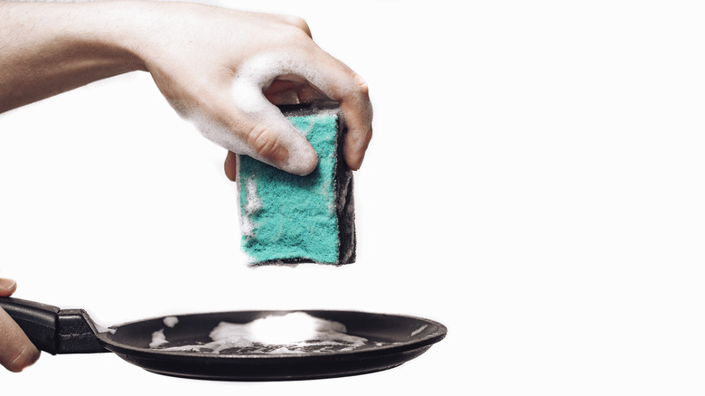 Person cleaning nonstick pan
