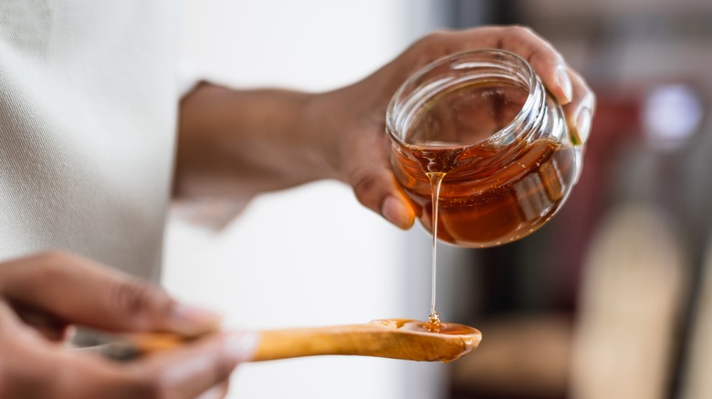 Honey being measured with a spoon