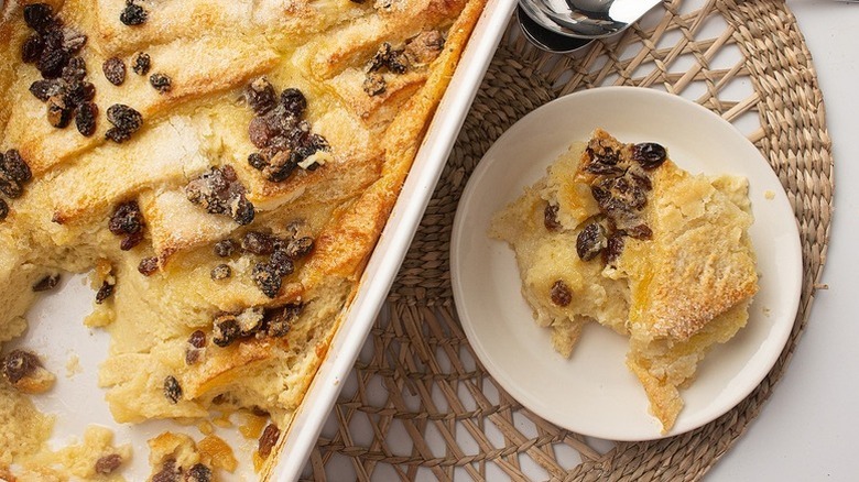 Bread and butter pudding in a white oven dish and dished onto a white plate