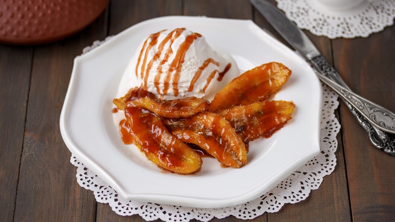 Plate of caramelized bananas with caramel sauce and ice cream