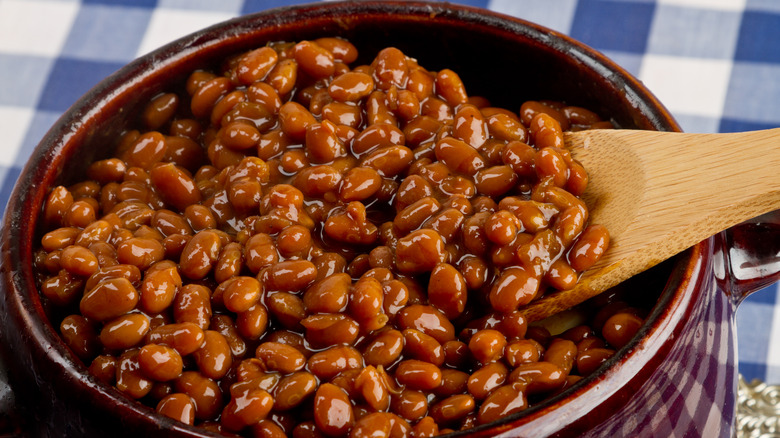 wooden spoon scooping baked beans