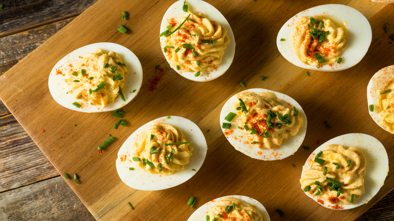 deviled eggs on wooden board