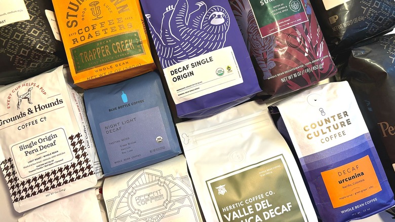 Collage of decaf whole bean coffee bags from various roasters