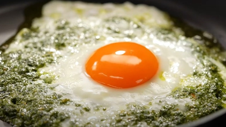 Pesto egg frying in pan