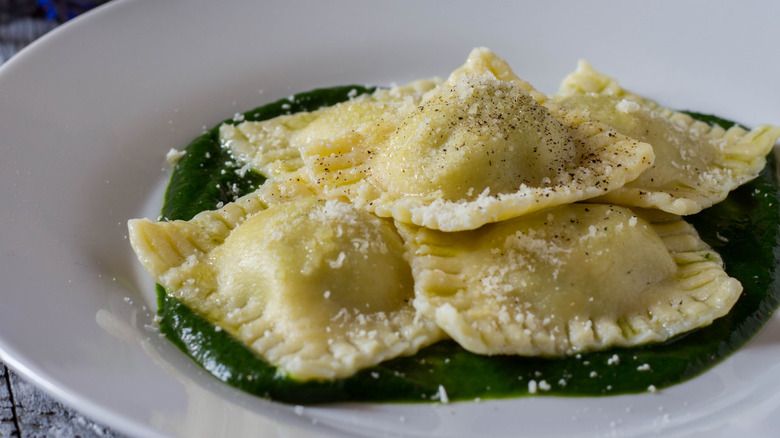 Ravioli pasta with grated Parmesan cheese and black pepper