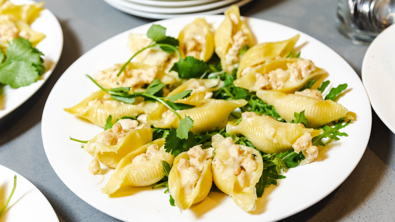 Stuffed pasta shells with fresh herb garnish