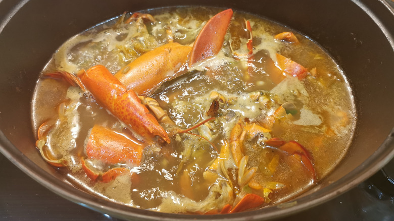 Lobster stock with shells cooking in pot