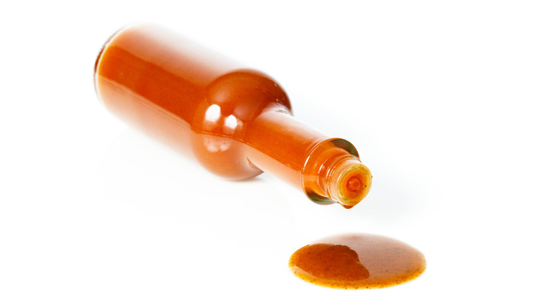 Hot sauce bottle and spilled sauce