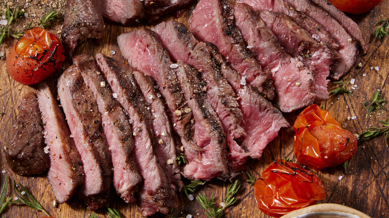 sliced steak tomatoes herbs