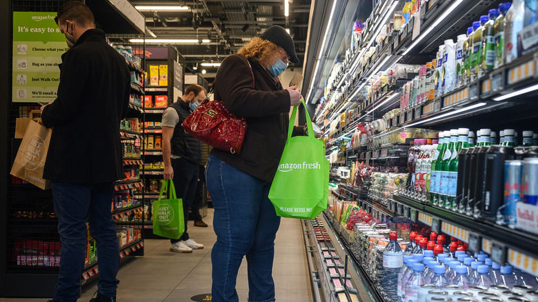 customers shopping inside Amazon Fresh grocery store