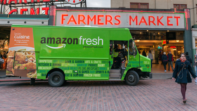 Amazon Fresh delivery truck in front of a farmers market