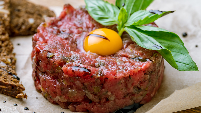 steak tartare with egg yolk and garnish 