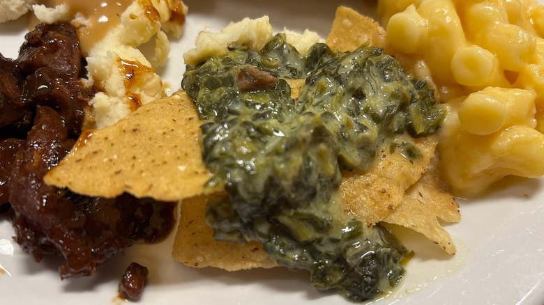 Golden Corral chips and creamed spinach on white plate