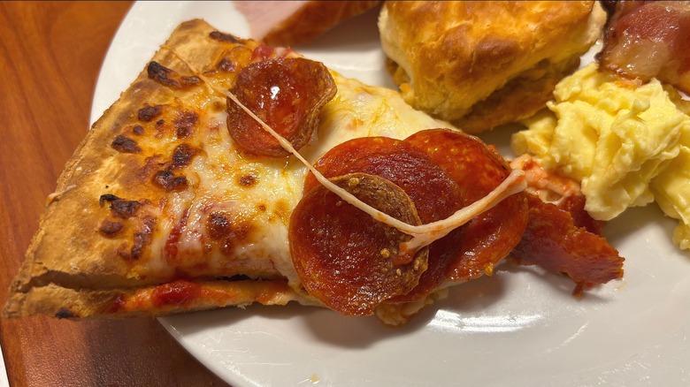 Slice of Golden Corral pepperoni pizza on white plate