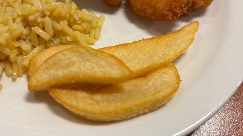 Golden Corral seasoned wedge fries on white plate