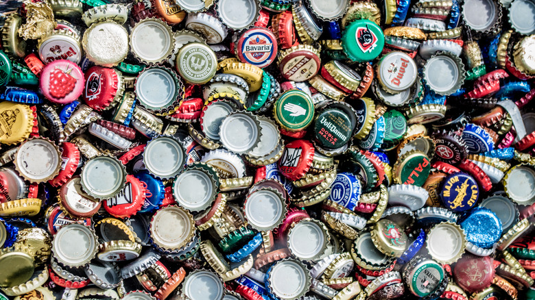 A mass of crown caps in a pile