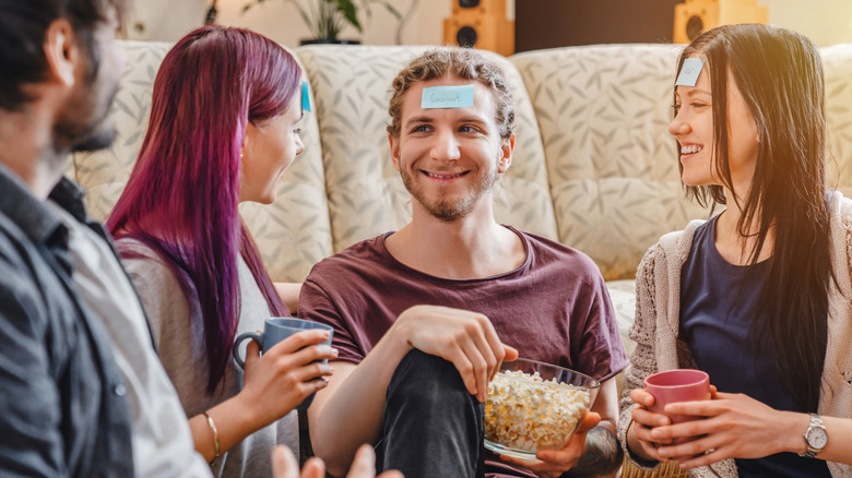Friends in a semi-circle with tags on their heads