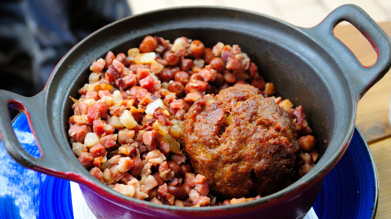 Bacon, meat, and beans in an iron pot