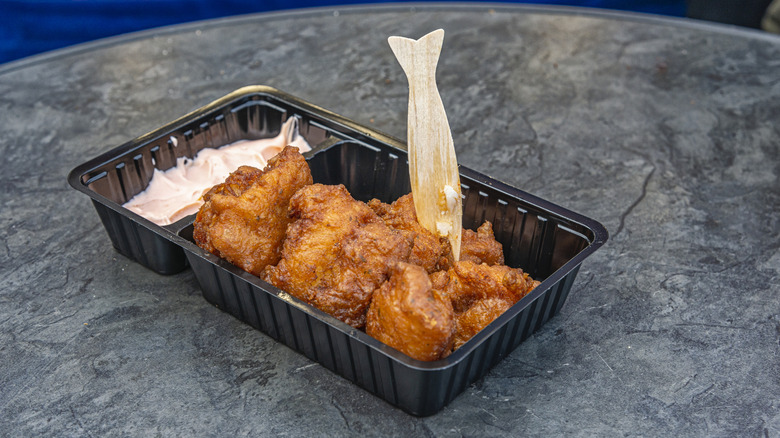 Dutch fried fish chunks, kibbeling, served in a plastic tray