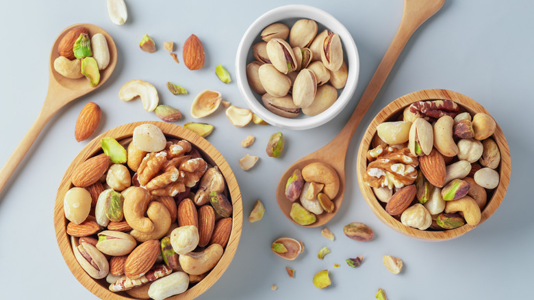 Three bowls full of mixed nuts