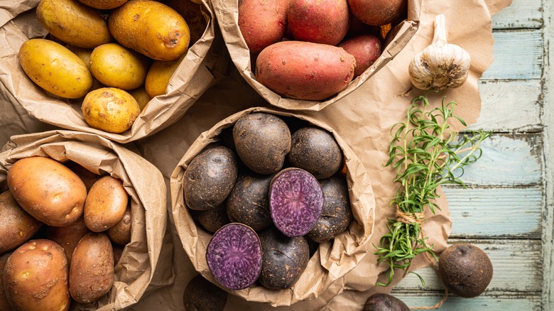 Various potatoes in paper bags