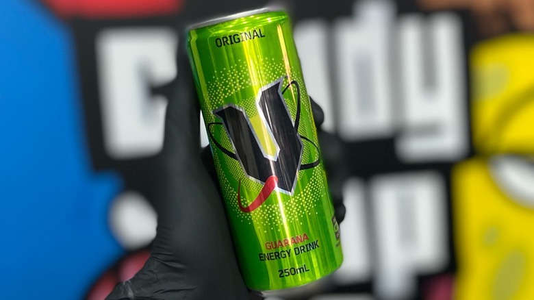 hand holding a can of V Green energy drink