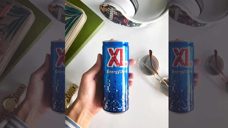 hand holding can of xl energy drink