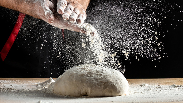 dusting flour making pizza dough