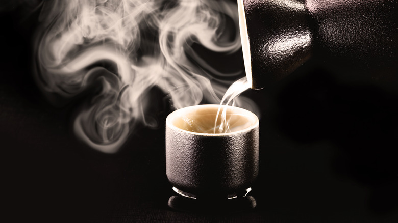 a steaming ceramic cup of hot sake