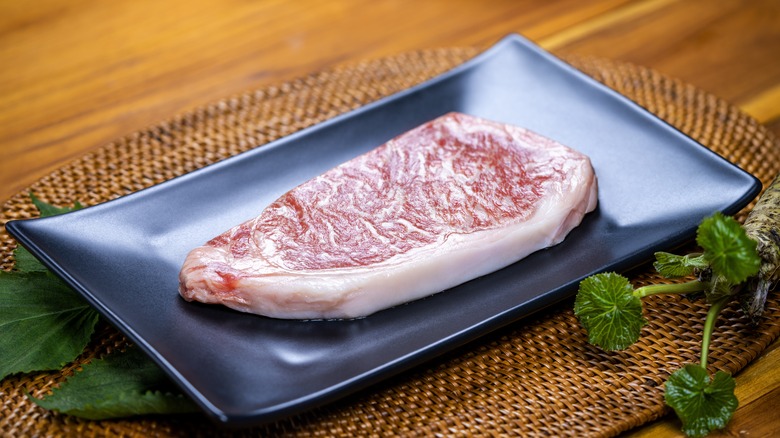 A piece of raw wagyu beef on a plate
