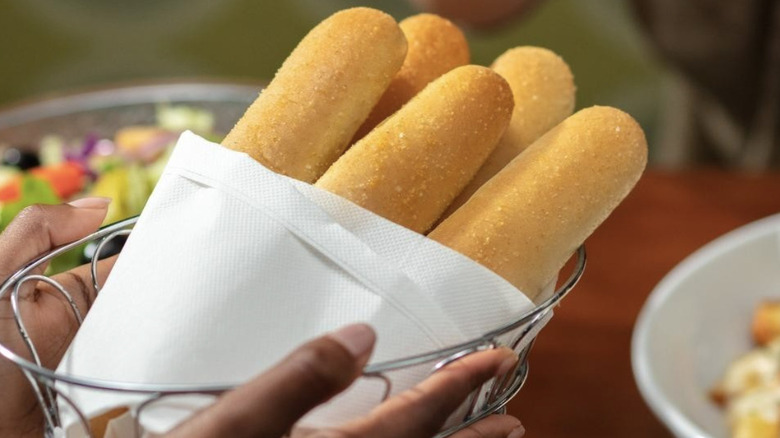 Holding Olive Garden breadsticks 