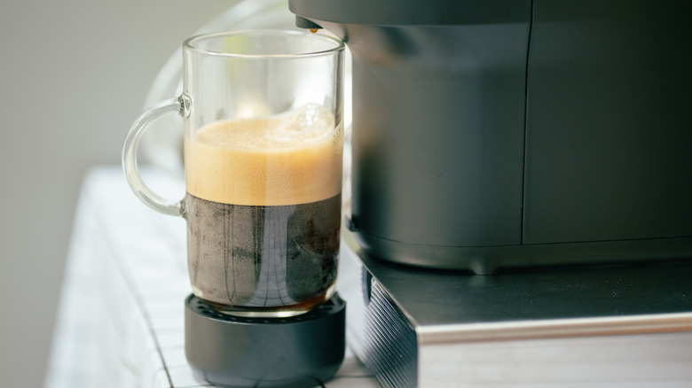 Fresh coffee underneath Nespresso machine