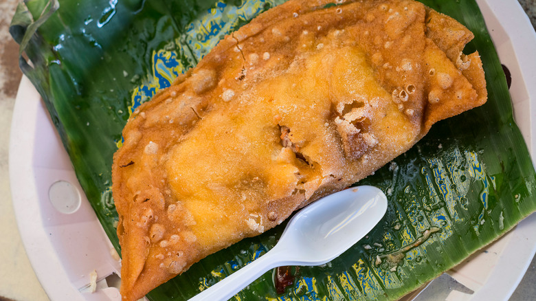 Filipino empanada with spoon