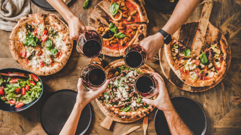 group with wine and pizza