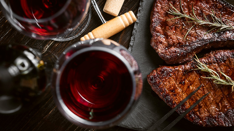 red wine glasses and steaks