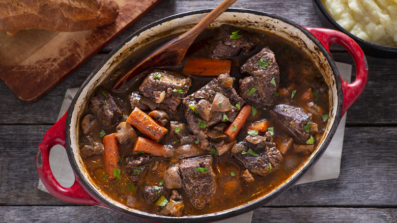 Beef stew in red enamel pot 