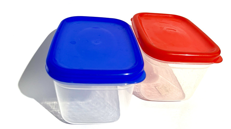 Pair of plastic food containers, one with a blue lid and one red