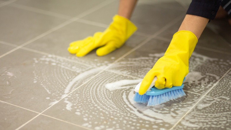 Person scrubbing kitchen floor