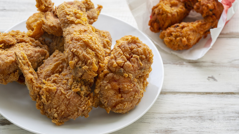 fried chicken on a plate and in a paper wrapper