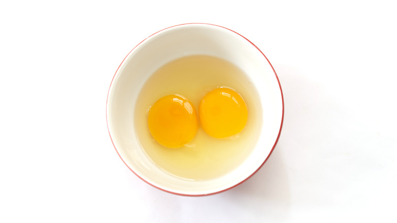 Two raw eggs in bowl