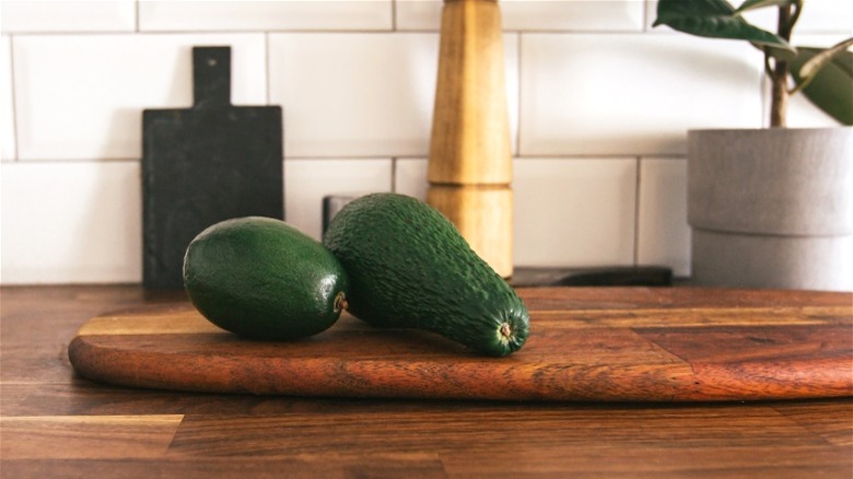 Unripe avocados on counter