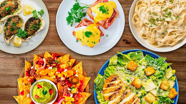 composite of oyster rockefeller, eggs benedict, fettucine alfredo, nachos, and caesar salad