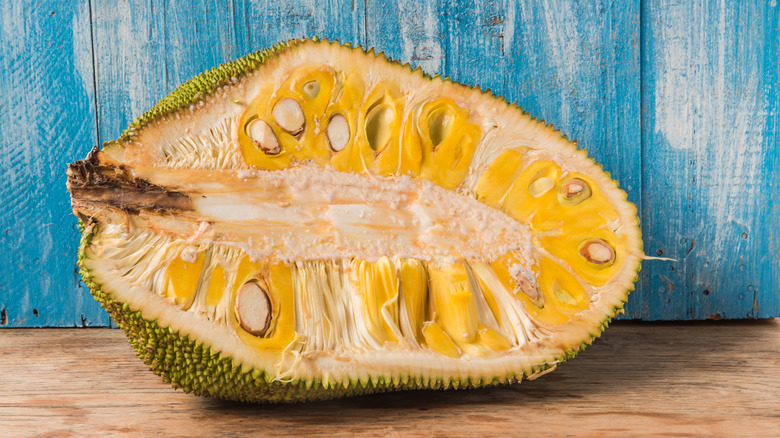 Halved jackfruit on wood table