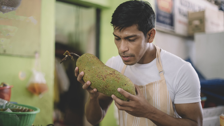 Person holding jackfruit