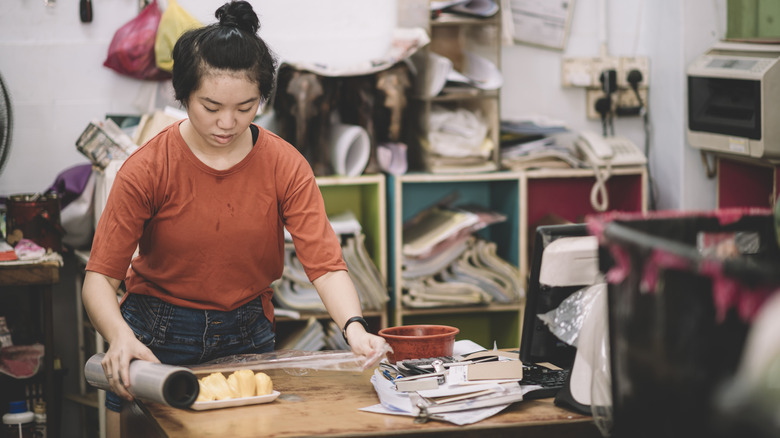 Person prepping jackfruit in kitchen