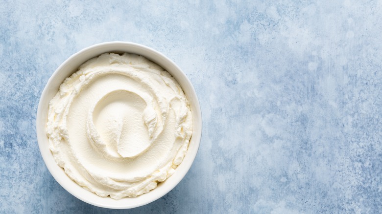 Mascarpone cheese against blue backdrop