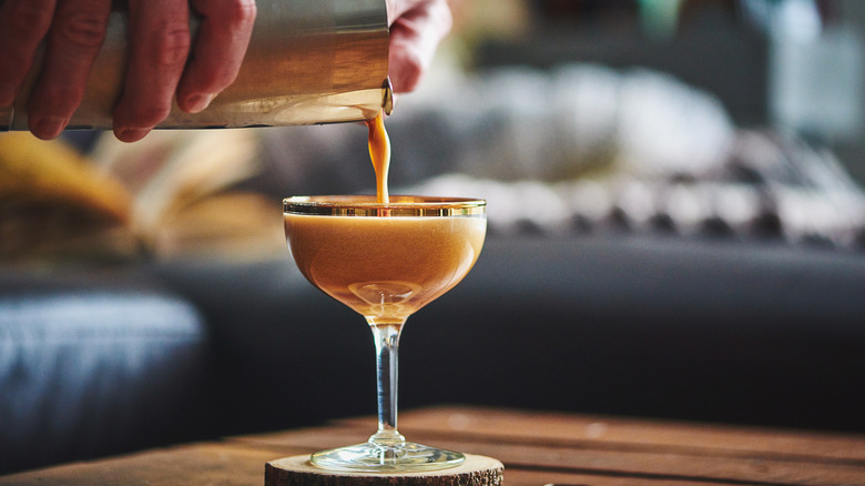 Hands pouring espresso martini 