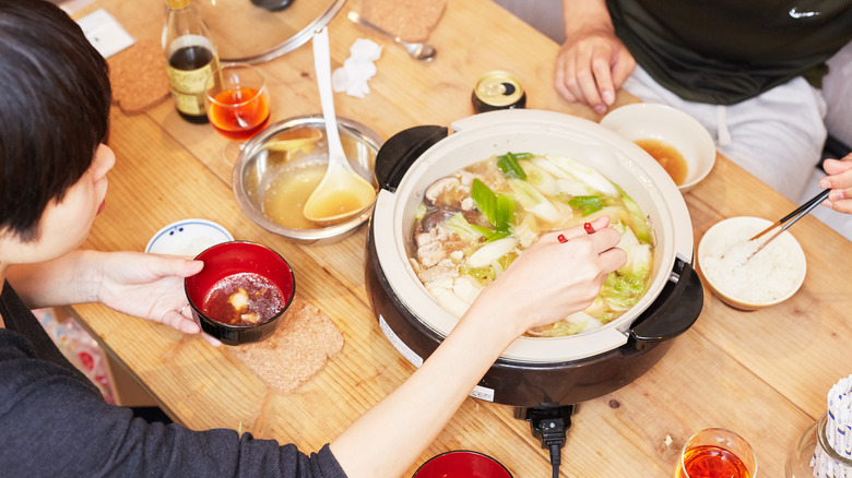 Two people share a hotpot 