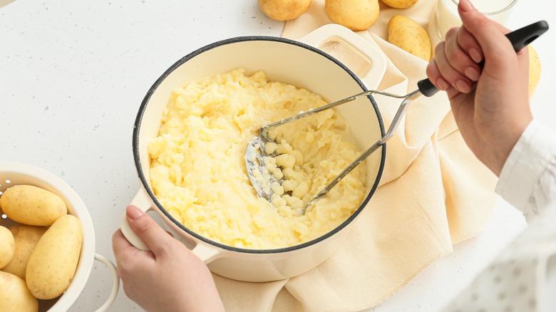 Potato masher in use